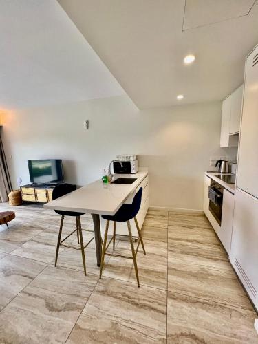 a kitchen with a table and chairs in a room at Emerald Suites in Protaras