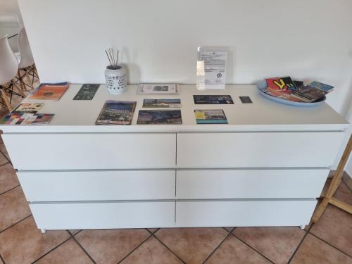 a white dresser with magazines and books on it at Case vacanze Chabloz in Nus