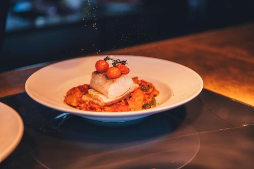 a white plate of food on a table at Slottsholmen Hotell och Restaurang in Västervik