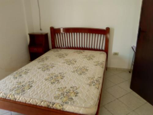 a bedroom with a bed with a floral mattress at AP DANTAS in Caraguatatuba