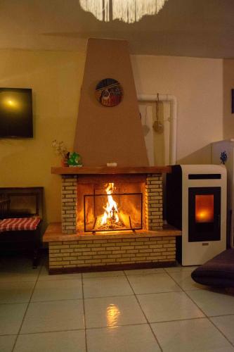 a brick fireplace in a living room with a fire at Guest Art Campitello Matese in San Massimo