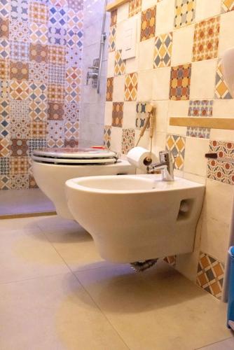 a bathroom with a toilet and a sink at Guest Art Campitello Matese in San Massimo