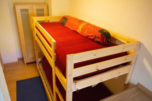 a wooden bunk bed with a red blanket on it at Guest Art Campitello Matese in San Massimo