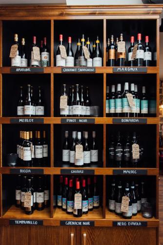 a shelf filled with lots of bottles of alcohol at Arthur's Bar & Accommodation in Southport