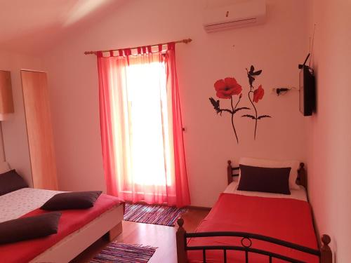 a bedroom with two beds and a window at Apartments Helena Pomer in Pomer
