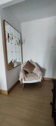 a room with a white couch and a mirror at Lagoas in Tavira