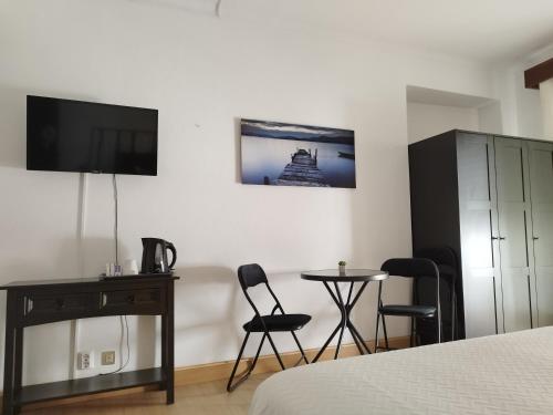 a bedroom with a bed and a table and chairs at Lagoas in Tavira
