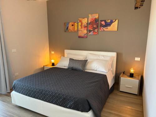 a bedroom with a large bed with two night stands at Hotel Panoramica in Bardolino