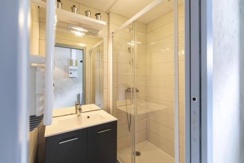 a bathroom with a sink and a shower at L'Esquiròu - Proche pistes pour 6 in Barèges