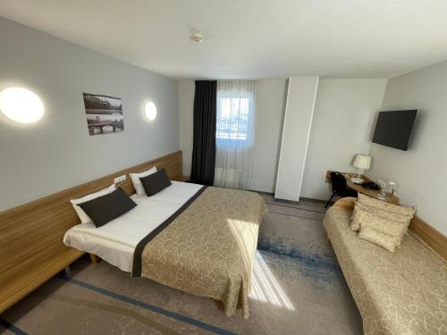 Postel nebo postele na pokoji v ubytování Green Vilnius Hotel