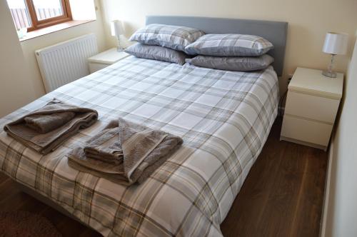 a bedroom with a bed with blankets and pillows at Stone Cottage in Shrewsbury