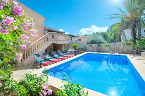 a swimming pool with chairs and a house at Owl Booking Villa Irina - 2 Min Walk To The Old Town in Pollença