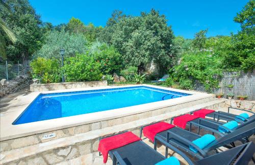 a swimming pool with chaises and chairs next to it at Owl Booking Villa Irina - 2 Min Walk To The Old Town in Pollença
