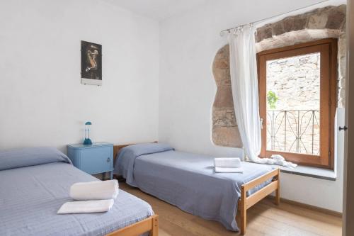 En eller flere senger på et rom på The Private Courtyard in Sardinia