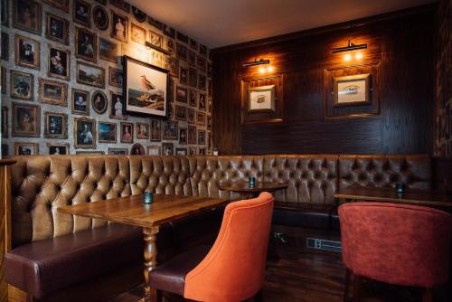 a restaurant with a table and chairs in a room at Arthur's Bar & Accommodation in Southport