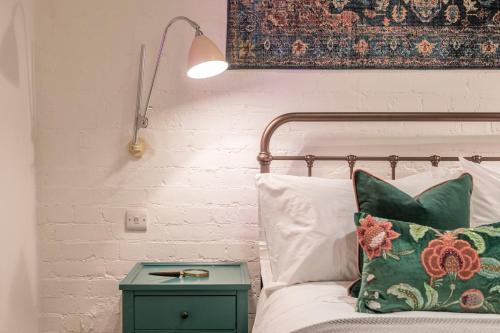 a bedroom with a bed with a green nightstand next to a bed with at A Starry Starry Night - Borough - by Frankie Says in London