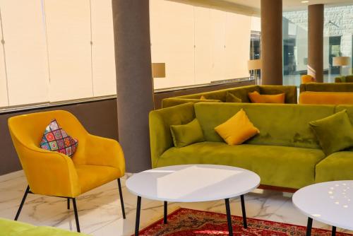 a living room with a couch and two chairs at The RN Hotels in Wadi Musa