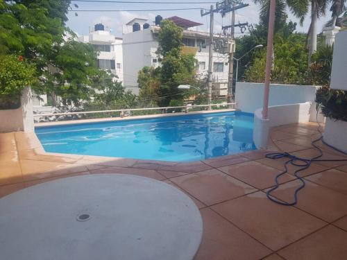 a swimming pool with blue water in a building at Departamento en Zona Dorada de Acapulco in Acapulco