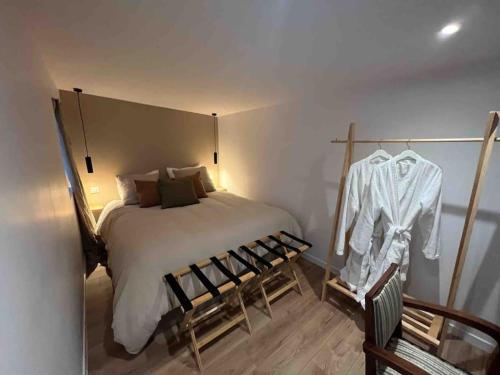 a bedroom with a bed and a shirt hanging on the wall at Casa Melodia in Pontoise