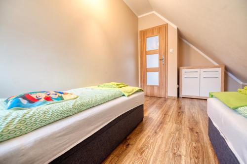 a small bedroom with a bed and a window at Domek na Kaszubach na Gwizdowce in Załakowo