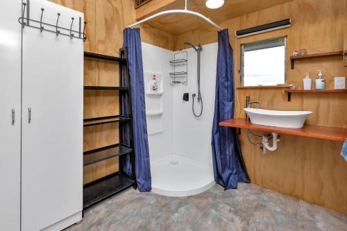 a bathroom with a shower and a sink at Waimate Farmstay - Kerikeri Holiday Home in Kerikeri
