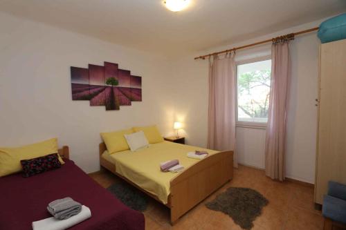 a bedroom with two beds and a window at Apartment in Silo/Insel Krk 13555 in Šilo