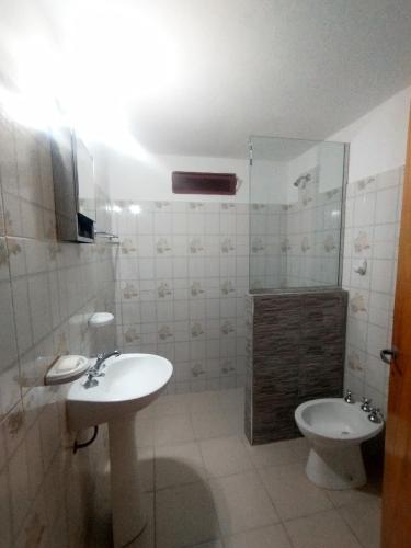 a bathroom with a sink and a toilet at Sierras Alojamiento in Mina Clavero