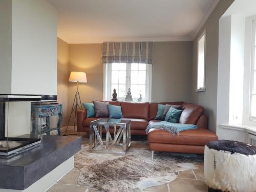 a living room with a couch and a table at Hotel Duene in Rantum