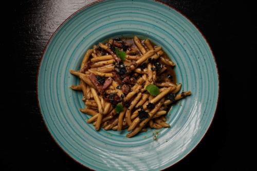 a blue plate of pasta on a table at Hotel Osejava in Makarska