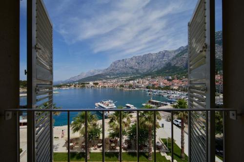 a view of a harbor from a balcony at Hotel Osejava in Makarska