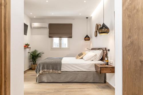 a small bedroom with a bed and a window at Galazia Boutique Apartments in Naxos Chora