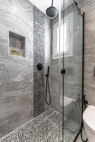 a shower with a glass door in a bathroom at Galazia Boutique Apartments in Naxos Chora