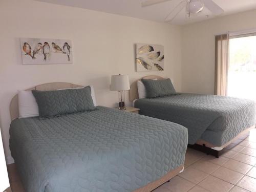a bedroom with two beds and a window at Close to Beach Brunswick Plantation Condo 2302M with 27 Hole Golf Course Onsite condo in Calabash