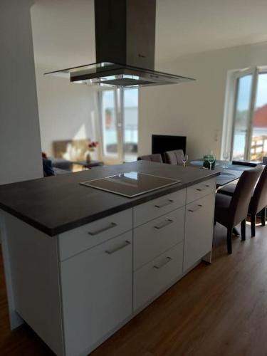 a kitchen with a island with a counter top at Große Moderne Penthouse Wohnung Mit Dachterrasse in Uetersen