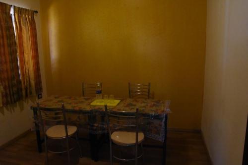 jadalnia ze stołem i krzesłami w pokoju w obiekcie Le Grace Apoorva w mieście Kodaikānāl