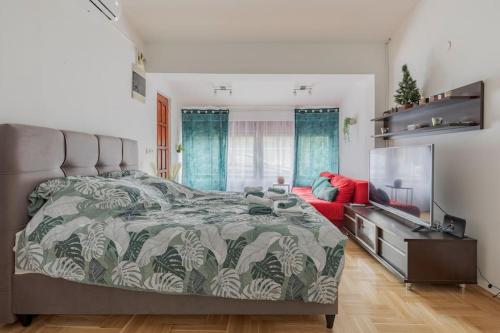 a bedroom with a large bed and a television at Warm house full of green ambient,joy and comfort in Zagreb