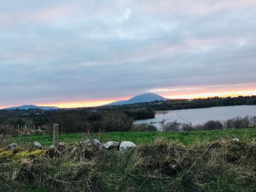 a view of a lake with a mountain in the background at Hillcrest farmhouse Bed & Breakfast in Boyhollagh