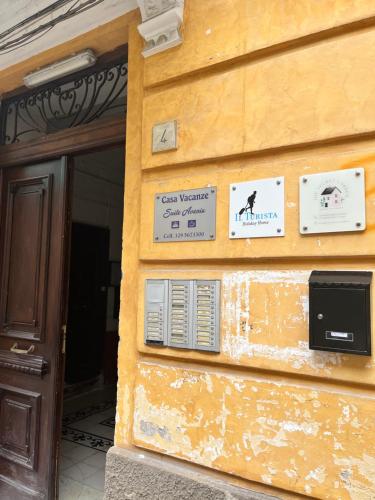 a building with signs on the side of it at The Secret Garden in Salerno