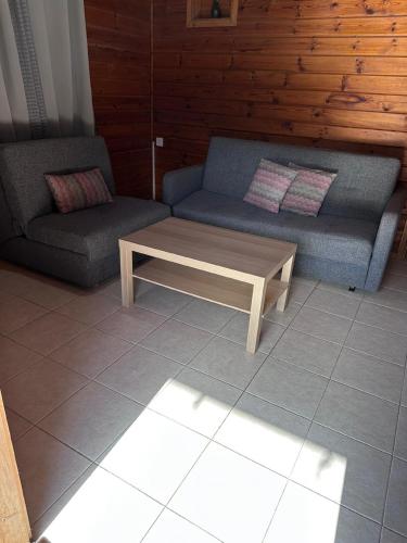 a living room with a couch and a coffee table at Arbel Holiday Homes in Arbel