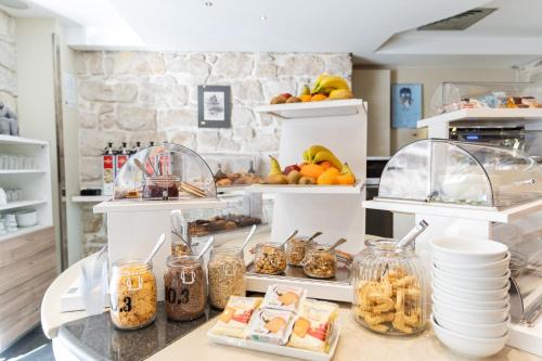 a kitchen with a counter with food on it at El Homs Palace Hotel in Comiso
