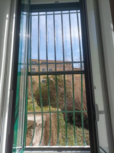 a window with a view of a field through it at The Secret Garden in Salerno