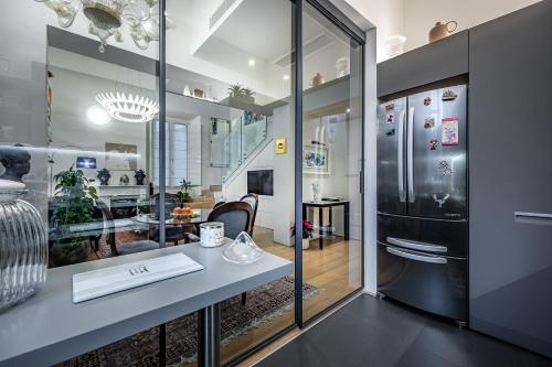 a kitchen with a counter and a refrigerator at YiD luxury & Design penthouse L5 in Florence