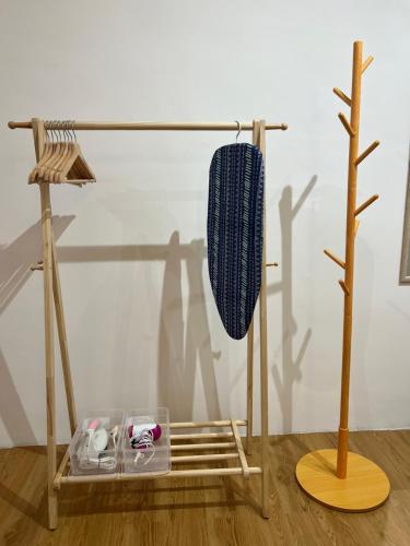 a wooden stand with a towel on it next to a tree at Infistay Homestay - Sunway Geo Avenue, Sunway Pyramid, Sunway Lagoon, Sunway University, Sunway Medical Centre in Subang Jaya