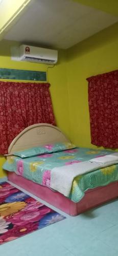 a small bedroom with a bed in a room at D'HANA HOMESTAY in Baling