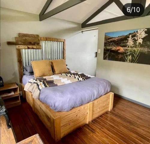 um quarto com uma cama grande num quarto em Treur River Lodge em Moremela