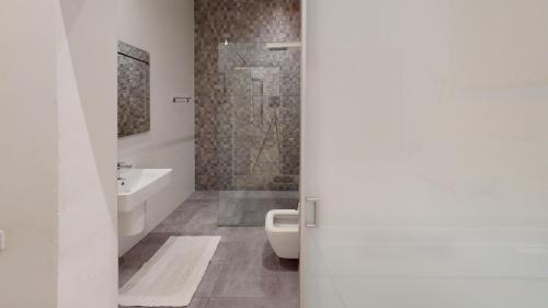 a bathroom with a shower and a toilet and a sink at Spacious 3 bedroom maisonette in Sliema