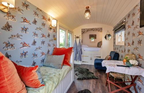 a room with a wall covered in horse decals at Finest Retreats - Shrawardine Train Carriage in Shrawardine