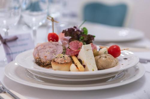 a plate of food sitting on a table at Hotel Leul de Aur in Sebeş