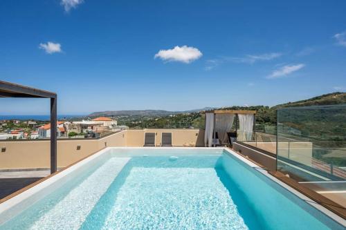 a swimming pool on the roof of a house at Casa Belvedere Apartments in Kournás
