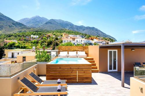 a balcony with a pool and mountains in the background at Casa Belvedere Apartments in Kournás